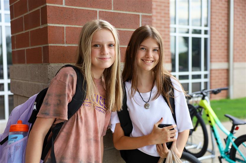 Two students smile
